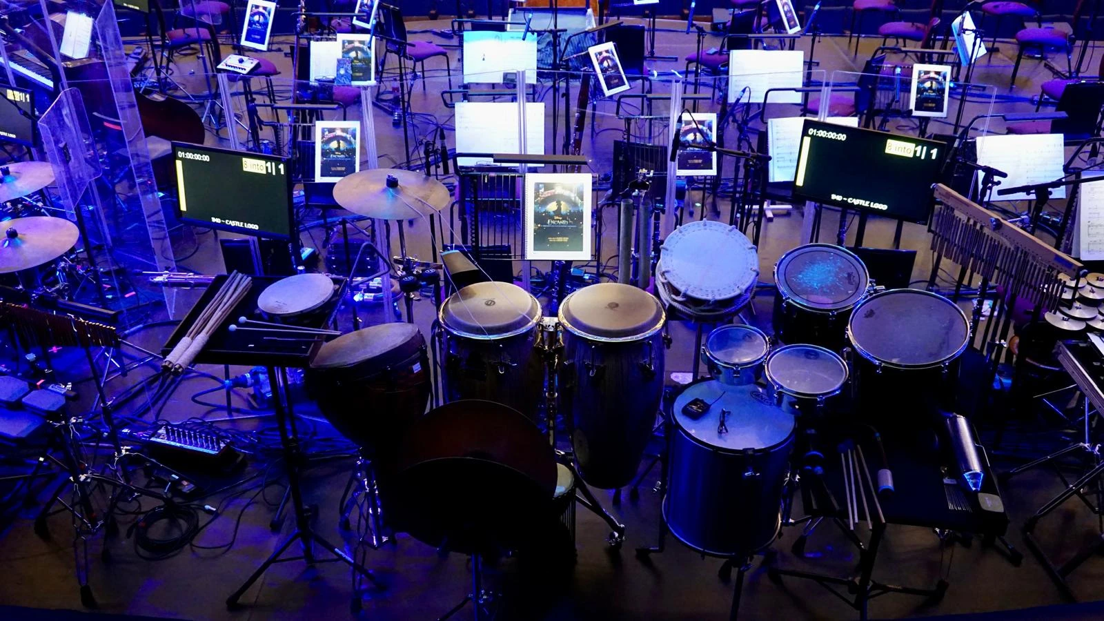 Orchestral percussion section including timpani and mallet instruments on stage